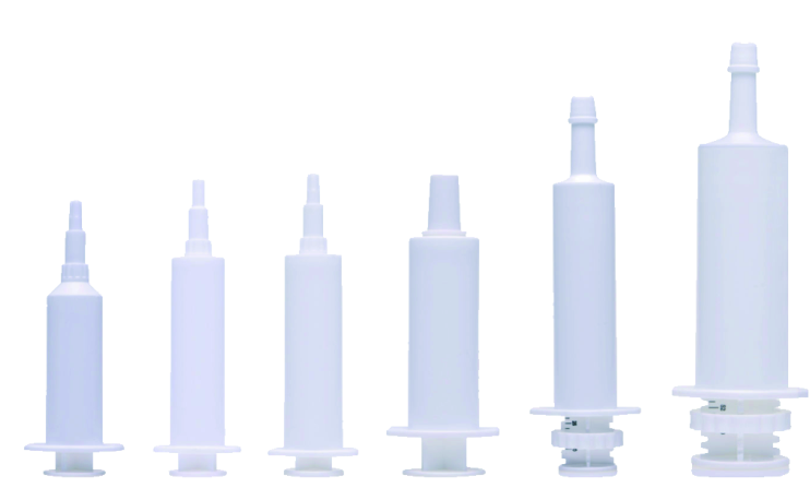 White plastic veterinary syringes in multiple sizes