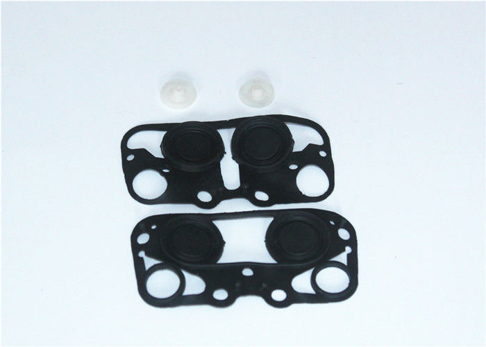 Milk pulsator membrane kit laid out for comparison
